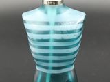 an image of a blue glass perfume bottle on a black surface