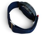 a close up of a watch on a white surface with a blue strap