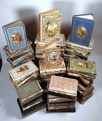 many books stacked on top of each other on a table