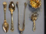 a lot of silver spoons and spoon spoons on a table