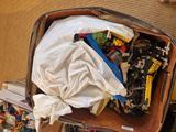 a suitcase full of legos sitting on the floor