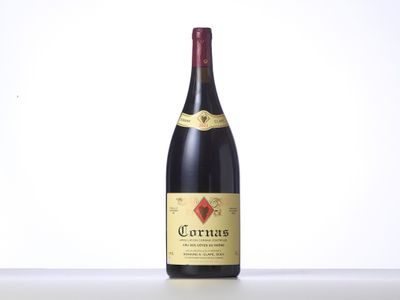 a bottle of red wine sitting on top of a table