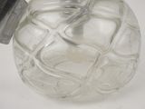 a clear glass bottle with a black lid