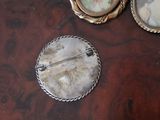 a picture of a brooch and a pin on a table