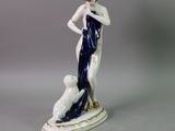 a figurine of a woman and a dog on a table