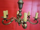 a chandelier that has five candles on each of it