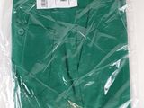 the green shirt is wrapped in plastic and ready to be shipped