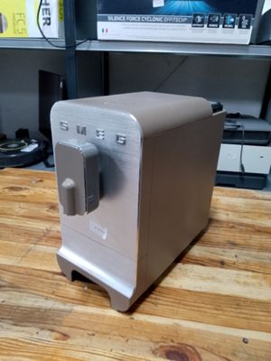 a toaster sitting on a wooden table in front of a tv