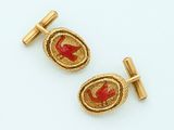 pair of gold and red enamel cufflinks with a bird on a branch