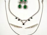 several pieces of jewelry are displayed on a white surface