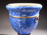 a blue vase that is sitting on a table