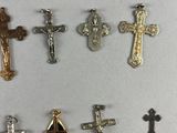 several different crosses are displayed on a white surface