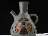 a vase that has a lot of stones inside of it