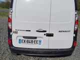a white van that is parked in a gravel lot