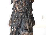 a statue of a woman that is standing on a white surface