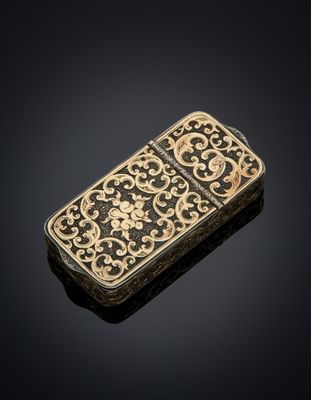 a gold - plated cigarette case with a floral design