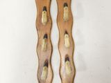 pair of wooden spoons with black and white designs on them