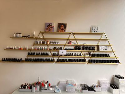 many bottles of nail polish on the shelves in the room