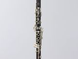 a close up of a clarinet on a stand against a white background