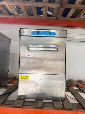 an image of a stainless steel dishwasher sitting on a pallet in a warehouse
