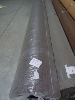 several rolls of fabric are stacked on top of each other in a warehouse