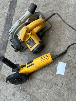 two electric tools on the ground next to each other