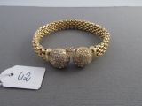 a close up of a bracelet on a table with a price tag