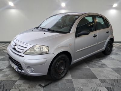 la photo d'une petite voiture argentée garée dans un garage