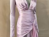 the mannequin is wearing a pink dress with long sleeves
