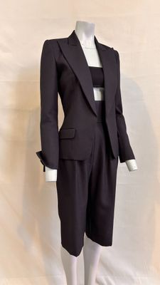 a mannequin wearing a suit and tie on a mannequin stand