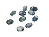 a group of blue and green gems on a white surface