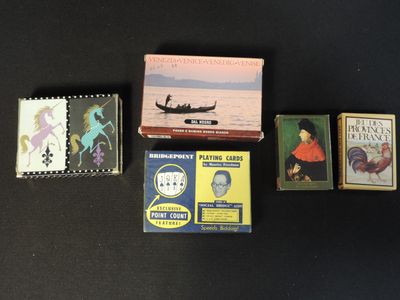 several books are sitting on a black surface next to each other
