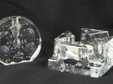 two pieces of glass sitting on a black surface