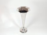 a glass vase with a black substance inside of it