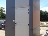 a portable toilet in the middle of a parking lot