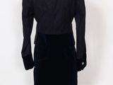 the back of a mannequin dress with a black jacket and skirt
