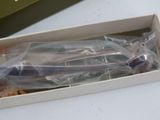a box of toothbrushes sitting on a table next to a box of cookies