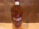 the bottle of grant ' s is sitting on a table