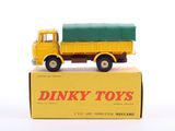 yellow and green dinky toy truck sitting on top of a box