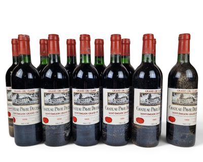 six bottles of red wine lined up in a row on a white surface