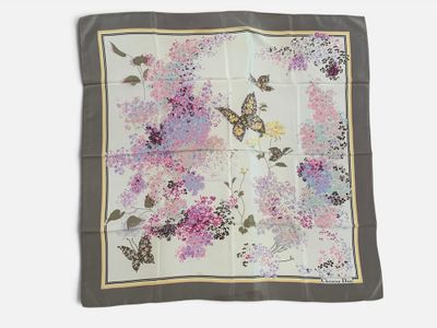a close up of a square scarf with flowers and butterflies