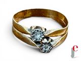 a gold ring with a blue stone in it