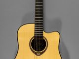 a small acoustic guitar on a gray background