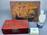 a small box with a statue of a man and a box with a statue of a man
