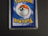 a close up of a pokemon card in a plastic case