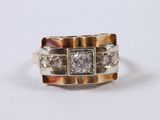 a close up of a ring with diamonds on a white surface