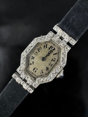 a close up of a wrist watch with diamonds on the face