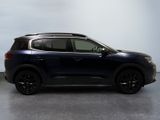 a blue suv parked in a room with a white wall