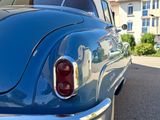 a blue car parked on the side of the street