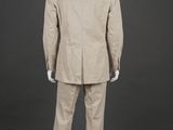 the back of a mannequin wearing a beige suit and white sneakers